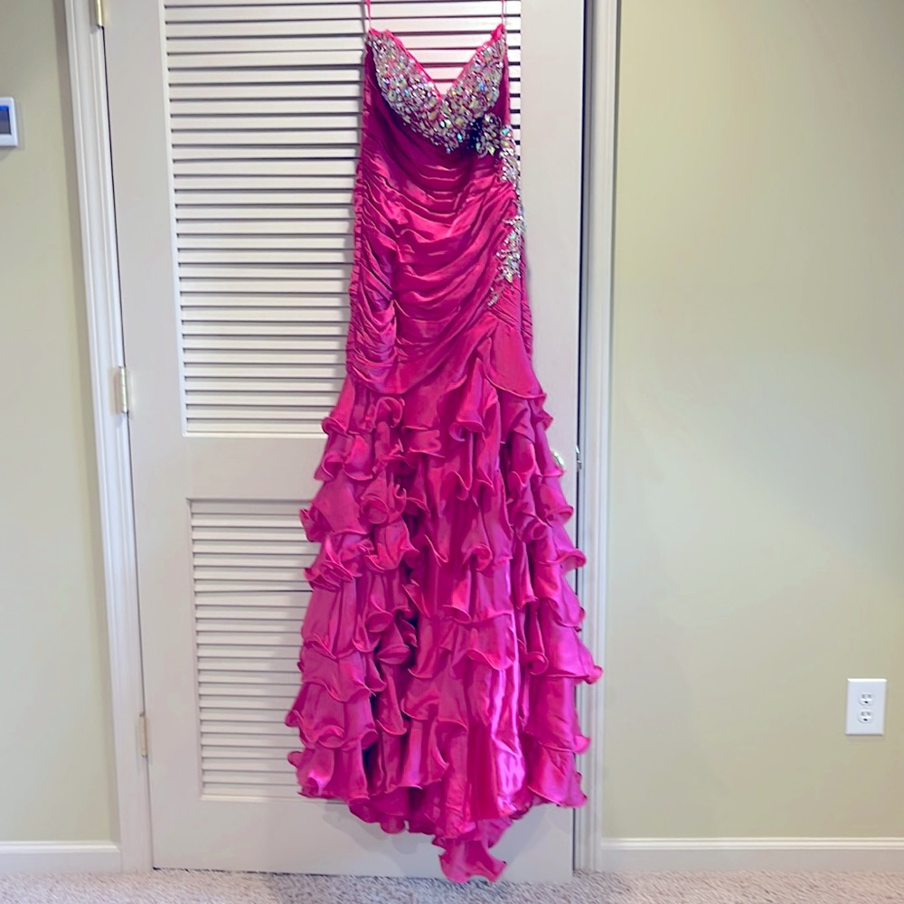 Mac Duggel prom dress size 10 strapless with a corset back. The color is fushia.